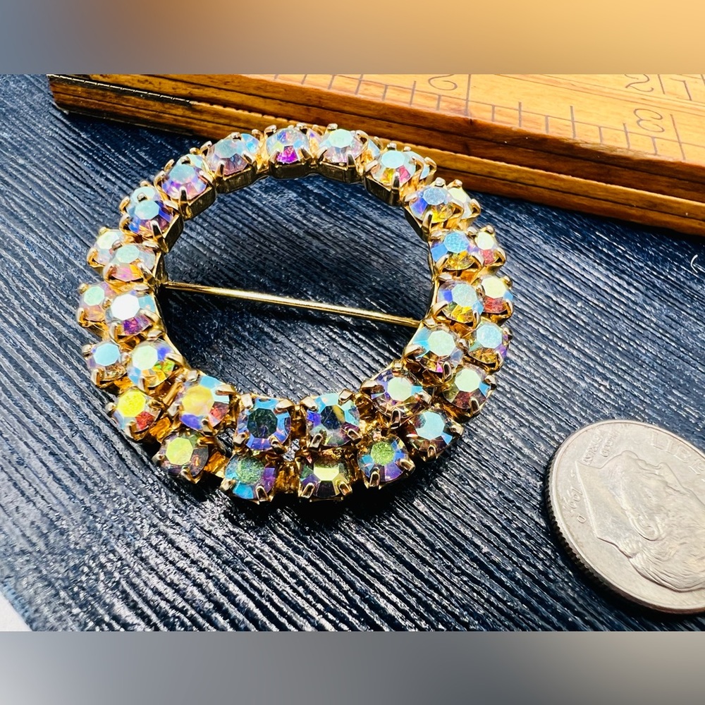 Vintage gold tone circle brooch with aurora borealis rhinestones